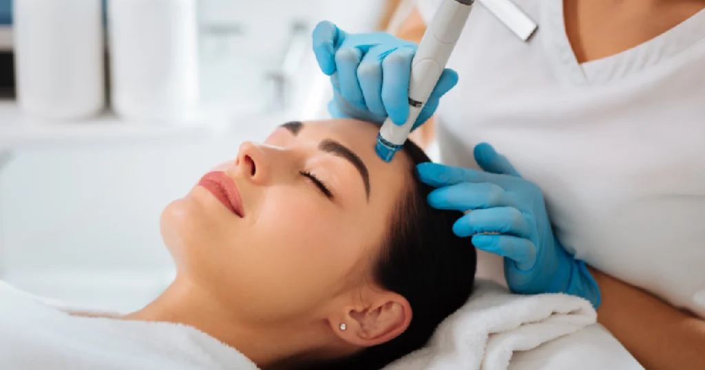 Current image: Aesthetic professional performing microneedling on female client representing Microneedling in Greeley, CO.